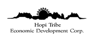 Hopi Tribe Economic Development Corp wordmark logo in black, with a stylised mesa and canyon skyline silhouette and a rising sun above the organisation name