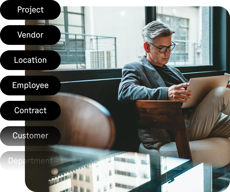 Illustration of Sage Intacct dimension tags stacked in a list including project, vendor, location, employee, contract, customer and department, alongside a finance leader working on a tablet