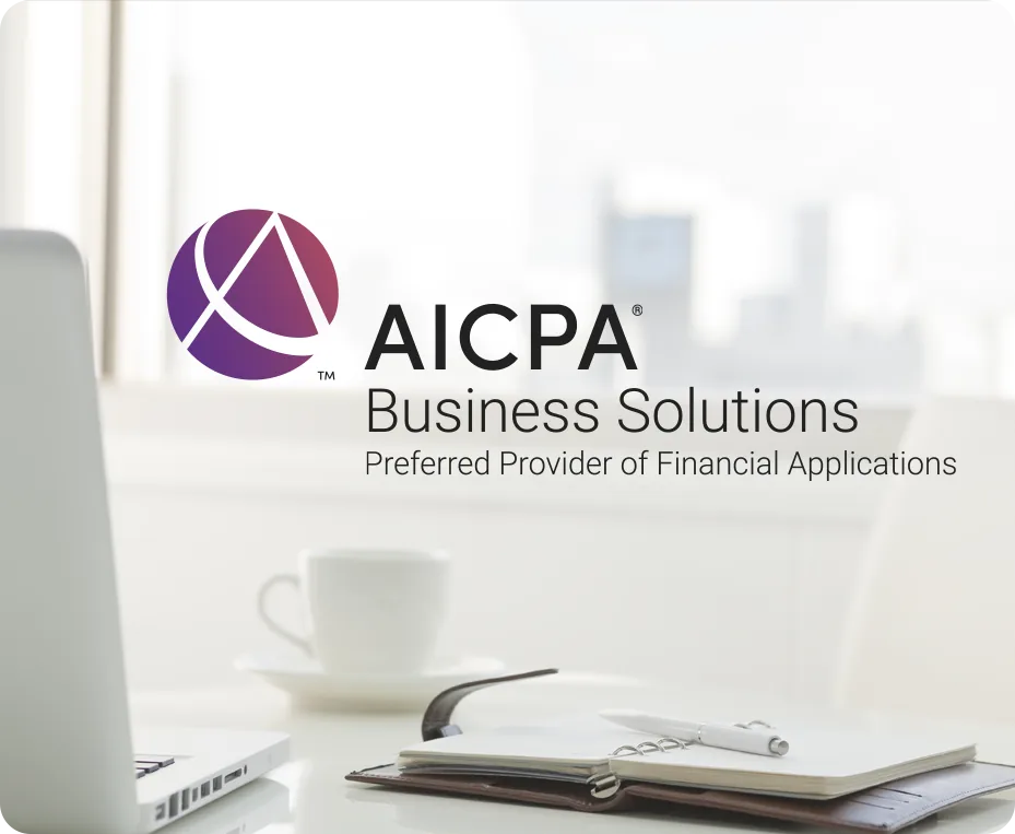 AICPA Business Solutions logo reading Preferred Provider of Financial Applications, set over a faded photograph of a desk with a laptop, an open notebook, a pen and a coffee cup