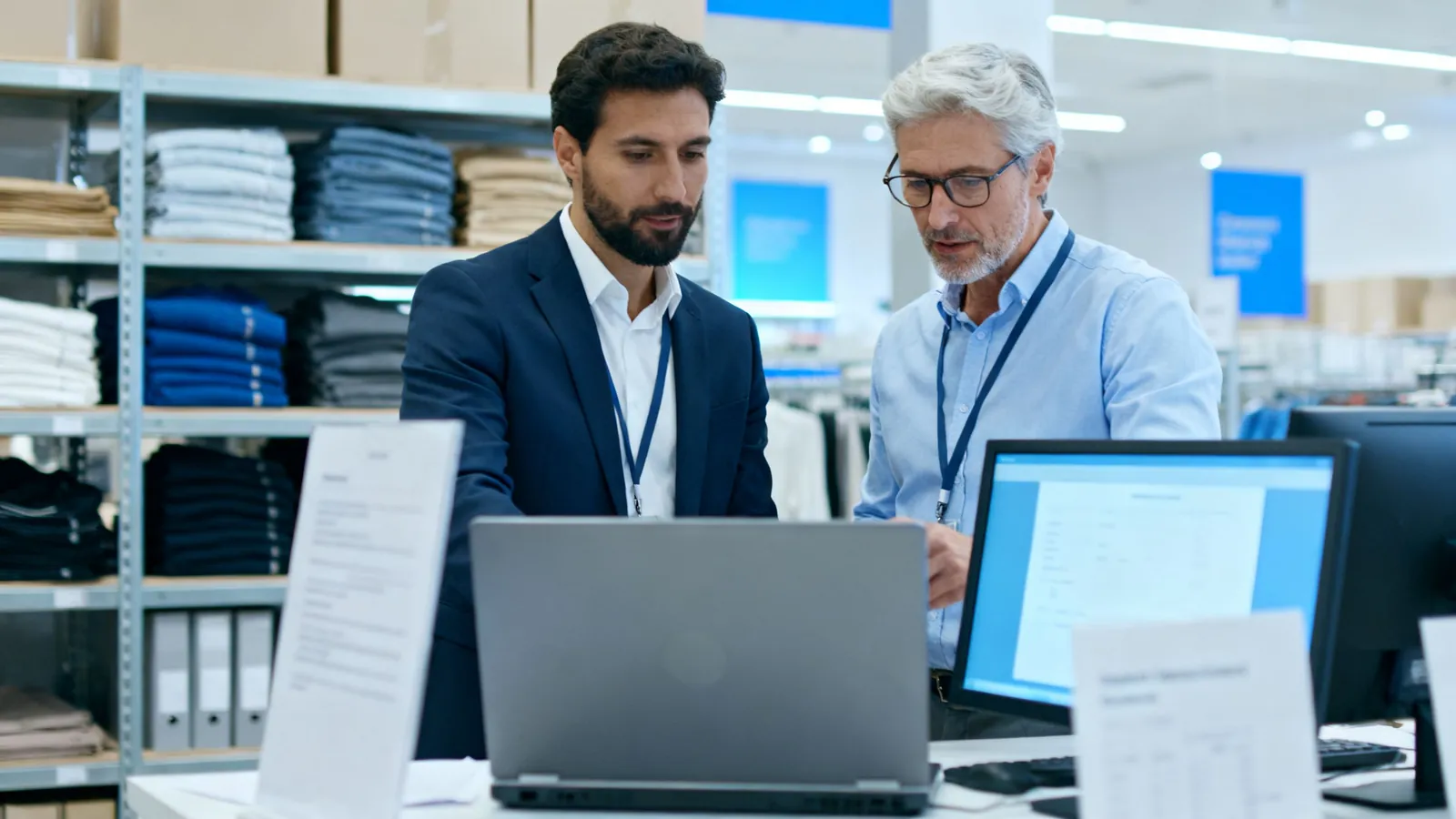A retail buyer and a finance manager in a stockroom